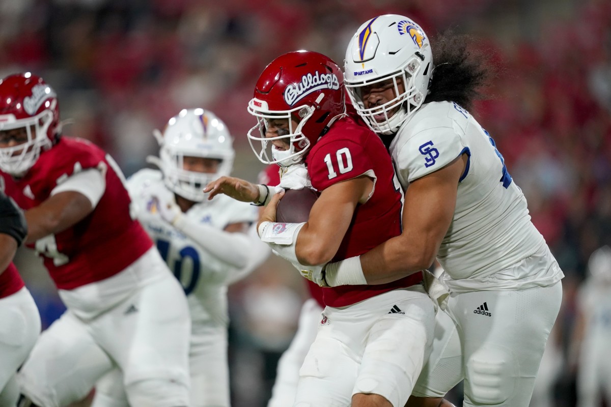 Oct 15, 2022; Fresno, California, USA; Fresno State Bulldogs quarterback Logan Fife (10) is sacked by San Jose State Spartans defensive lineman Viliami Fehoko (42) in the first quarter at Valley Children's Stadium. Mandatory Credit: Cary Edmondson-USA TODAY Sports