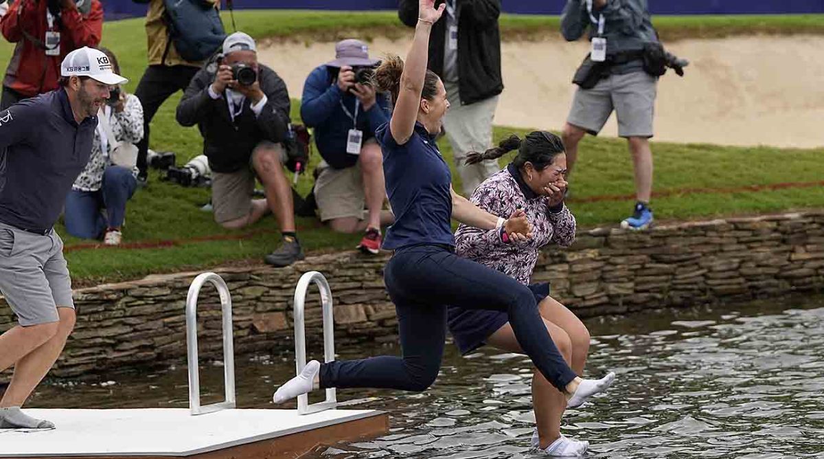 Lilia Vu (right) jumps into a pond after winning the 2023 Chevron Championship.