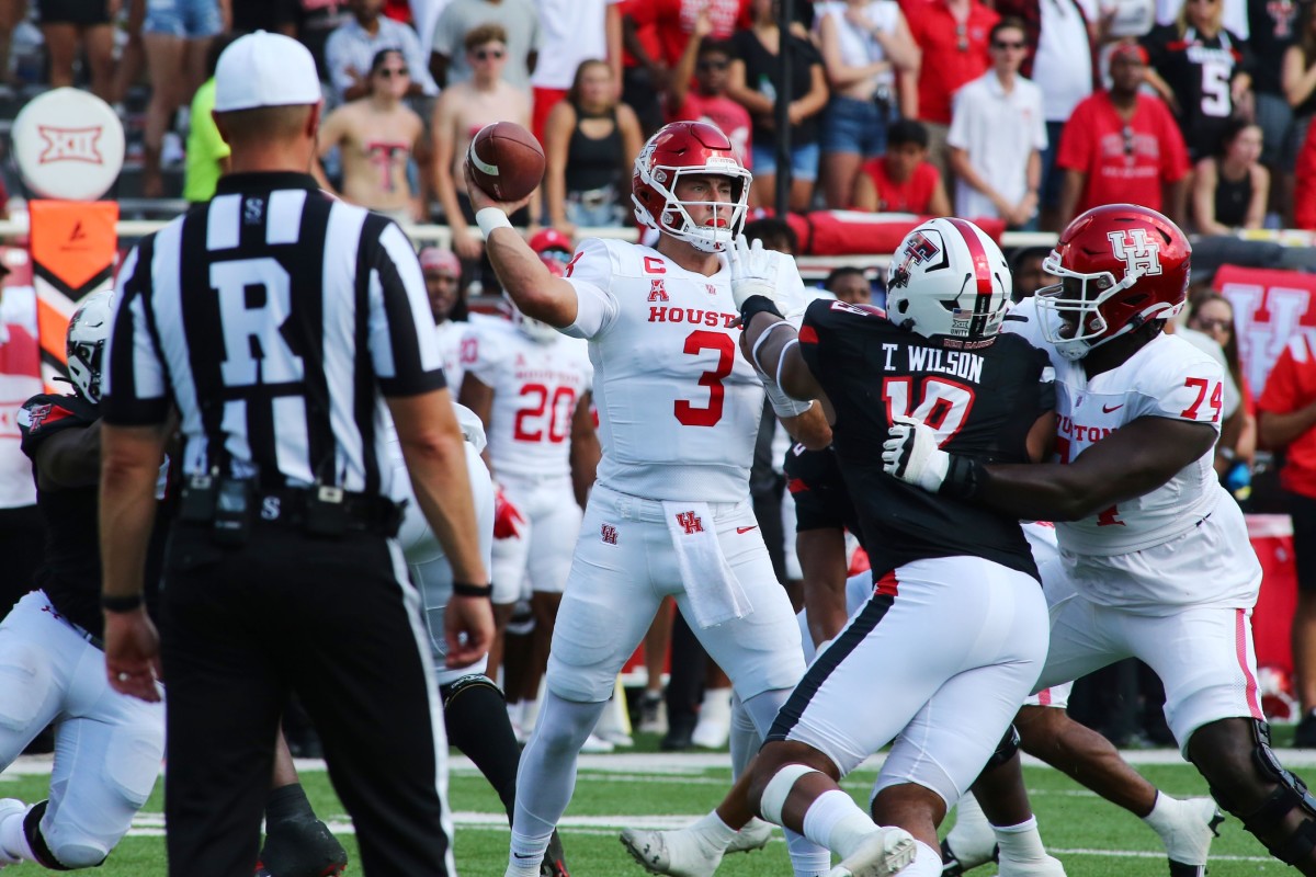 Sep 10, 2022; Lubbock, Texas, USA; Houston Cougars quarterback Clayton Tune (3) is pressured by Texas Tech Red Raiders defensive cornerback Tyree Wilson (19) in the first half at Jones AT&T Stadium and Cody Campbell Field. Mandatory Credit: Michael C. Johnson-USA TODAY Sports