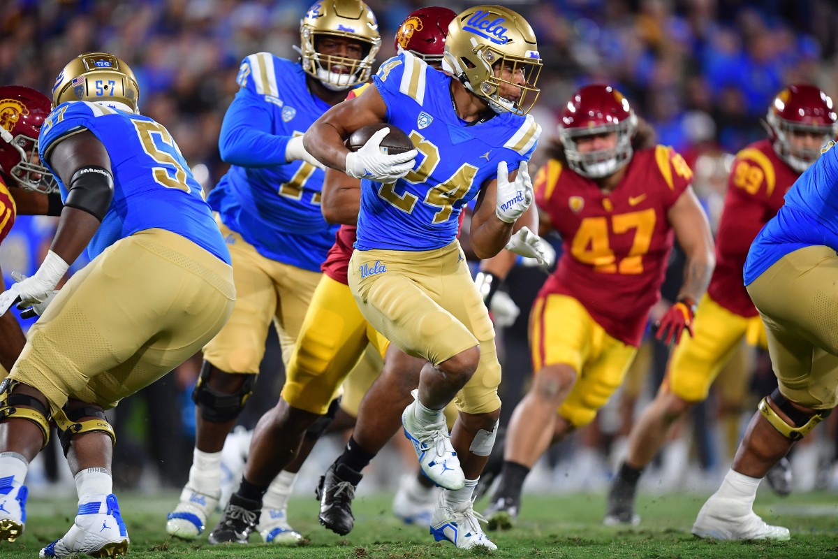 Nov 19, 2022; Pasadena, California, USA; UCLA Bruins running back Zach Charbonnet (24) runs the ball against the Southern California Trojans during the first half at the Rose Bowl. Mandatory Credit: Gary A. Vasquez-USA TODAY Sports