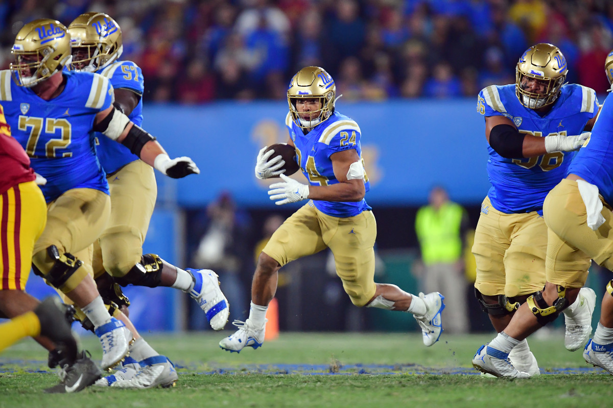 UCLA Bruins running back Zach Charbonnet (24) runs the ball against the Southern California Trojans during the first half at the Rose Bowl.