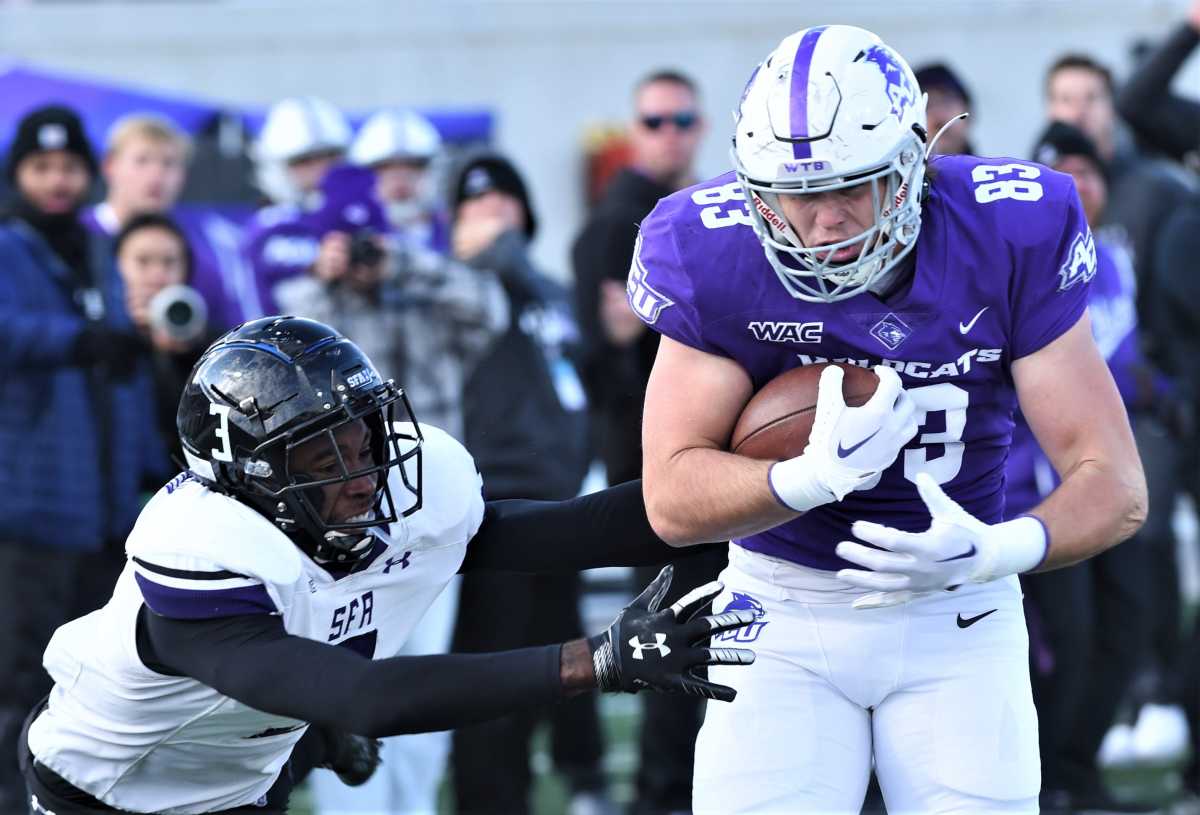 Colt Cooper, right, rumbles toward the end zone as SFA's B.J. Thompson defends. It went for a 32-yard TD pass as ACU took a 21-13 lead with 4:41 to play in the third quarter. The Lumberjacks beat ACU 24-21 for the Western Athletic Conference title Saturday, Nov. 19, 2022, at Wildcat Stadium. Acu Sfa 5
