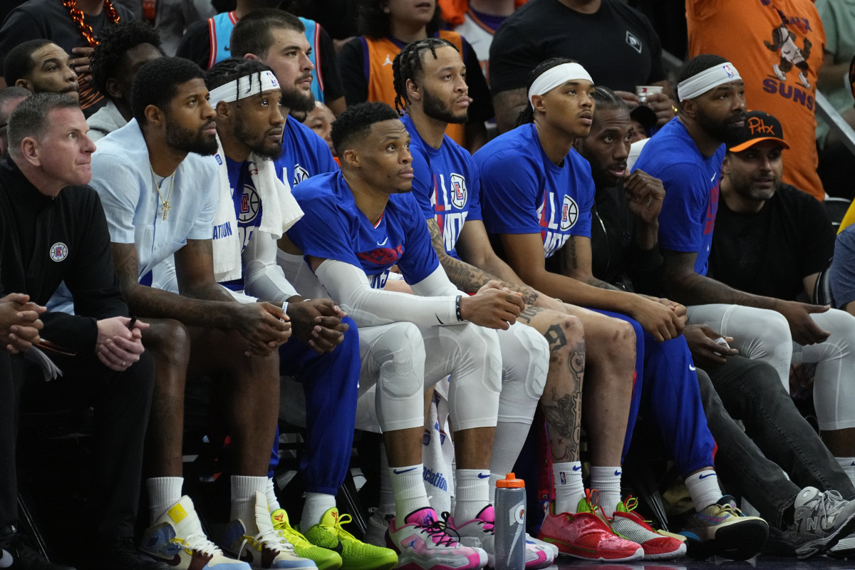 Players sit at the Clippers’ bench, looking dejected after losing in the first round.