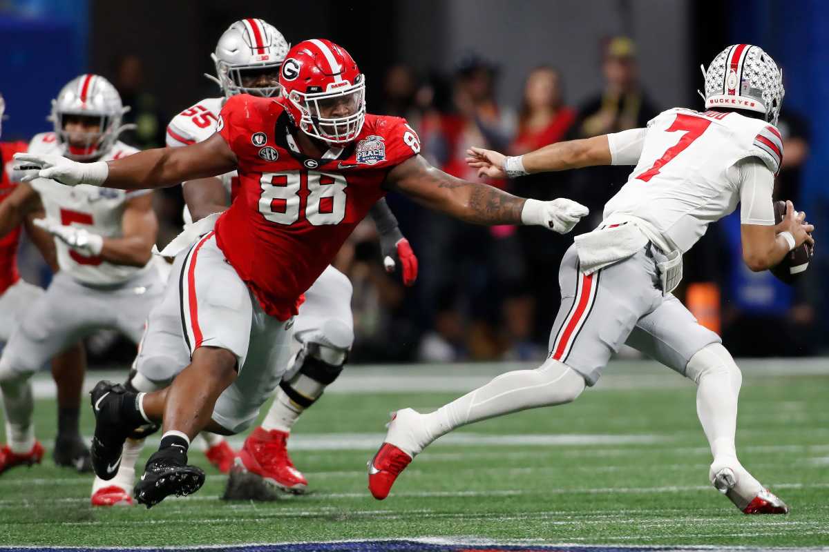 Ohio State quarterback C.J. Stroud (7) escapes a tackle from Georgia defensive lineman Jalen Carter (88) during the first half of the Chick-fil-A Peach Bowl NCAA College Football Playoff semifinal game on Dec 31, 2022, in Atlanta. News Joshua L Jones
