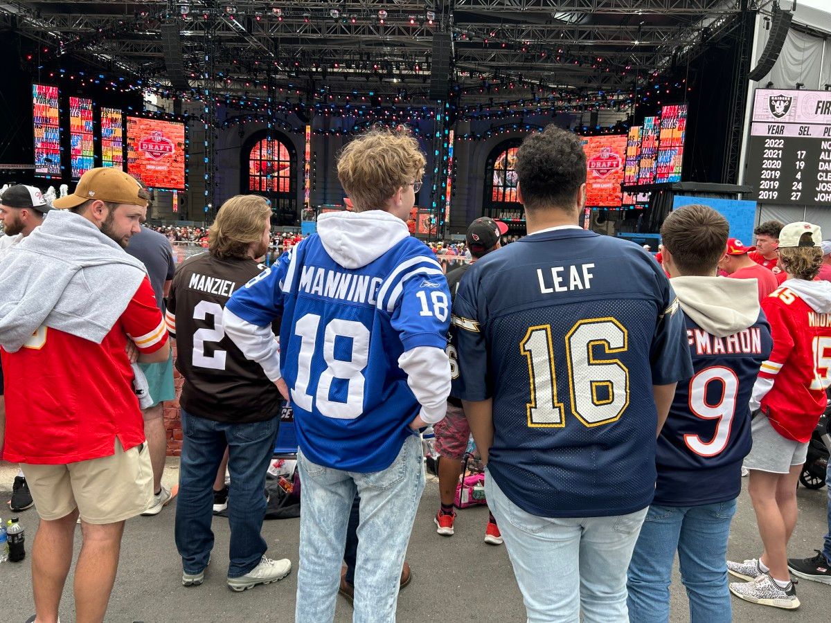 The perfect picture for how some NFL drafts go great for one team (Peyton Manning and the Indianapolis Colts) and not so great for others (Ryan Leaf and the San Diego Chargers). A perfect fan shot from Kansas City. (AllTitans.com photo by Tom Brew)