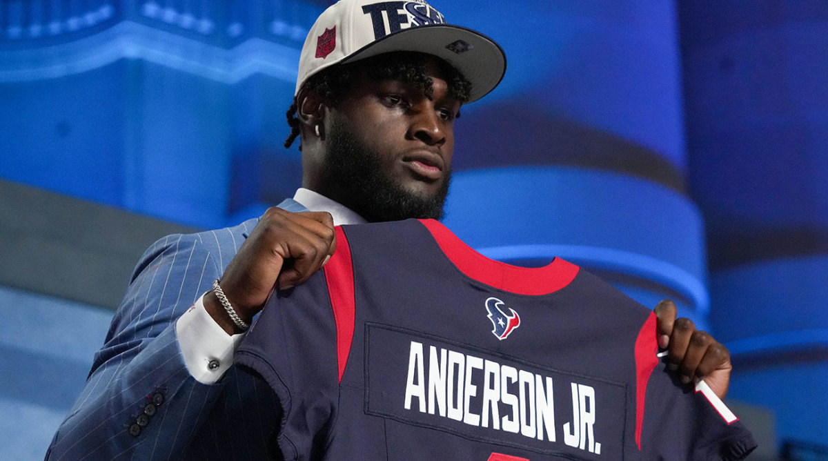 Will Anderson Jr. holds a Texans jersey after being selected in the first round of the NFL draft.