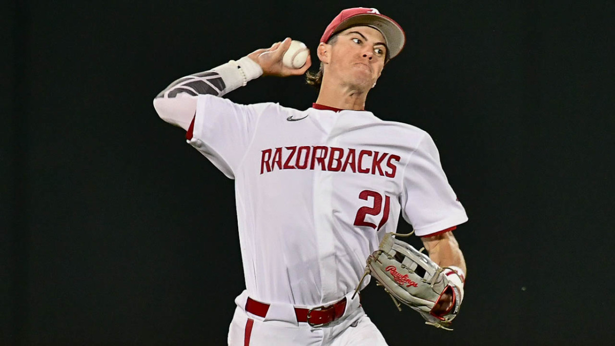 Razorbacks Hunter Grimes makes a throw from left field against Texas A&M