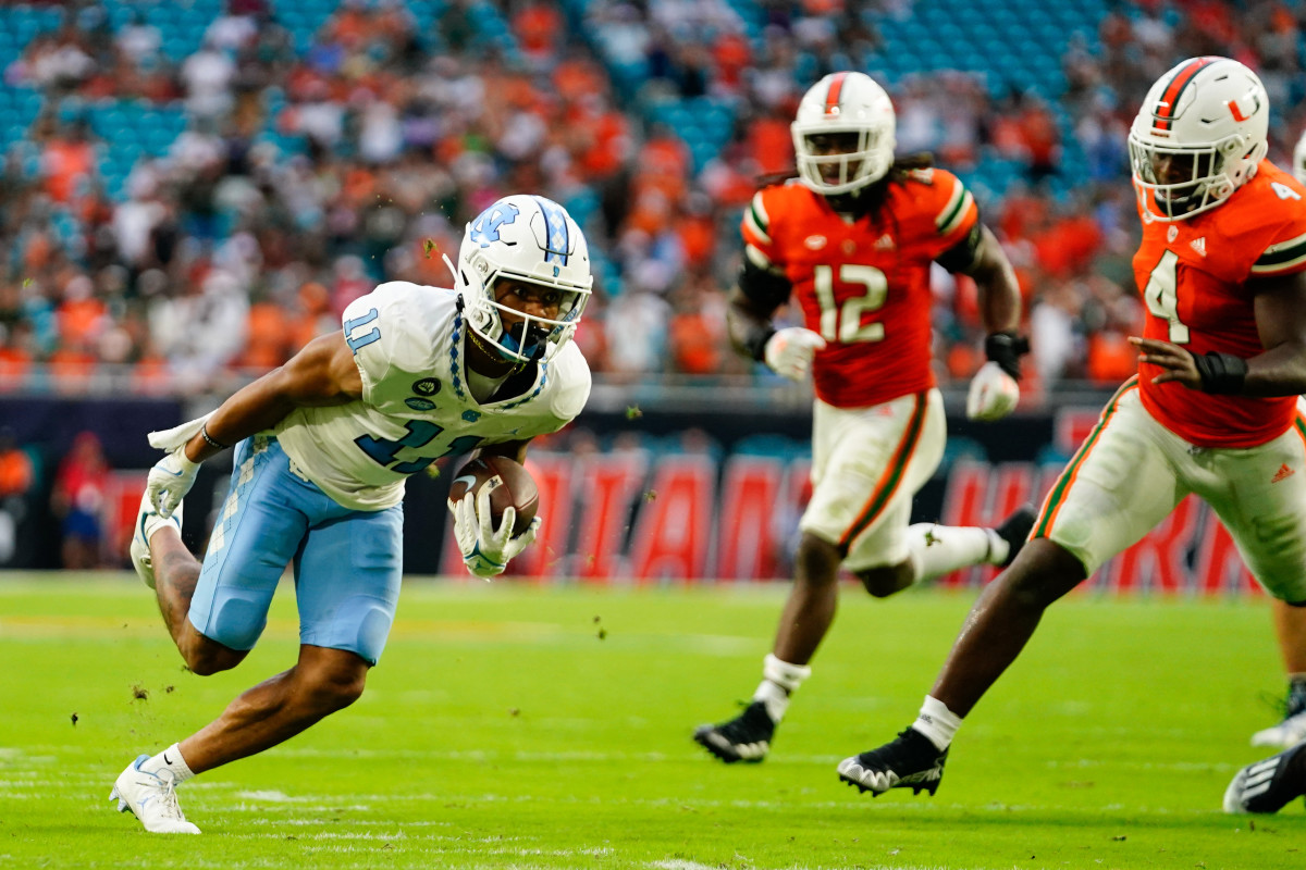 Oct 8, 2022; Miami Gardens, Florida, USA; North Carolina Tar Heels wide receiver Josh Downs (11) runs the ball for a touch down against the Miami Hurricanes during the first half at Hard Rock Stadium. Mandatory Credit: Rich Storry-USA TODAY Sports