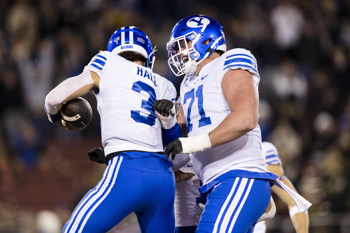 Nov 26, 2022; Stanford, California, USA; Brigham Young Cougars quarterback Jaren Hall (3) celebrates with offensive lineman Blake Freeland (71) after scoring a touchdown against the Stanford Cardinal during the first half at Stanford Stadium. Mandatory Credit: John Hefti-USA TODAY Sports