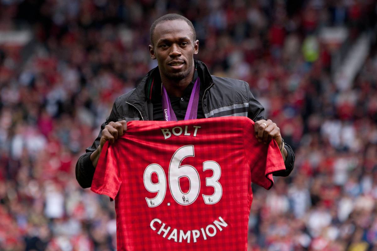 Usain Bolt pictured holding a Manchester United jersey during an appearance at Old Trafford in 2012