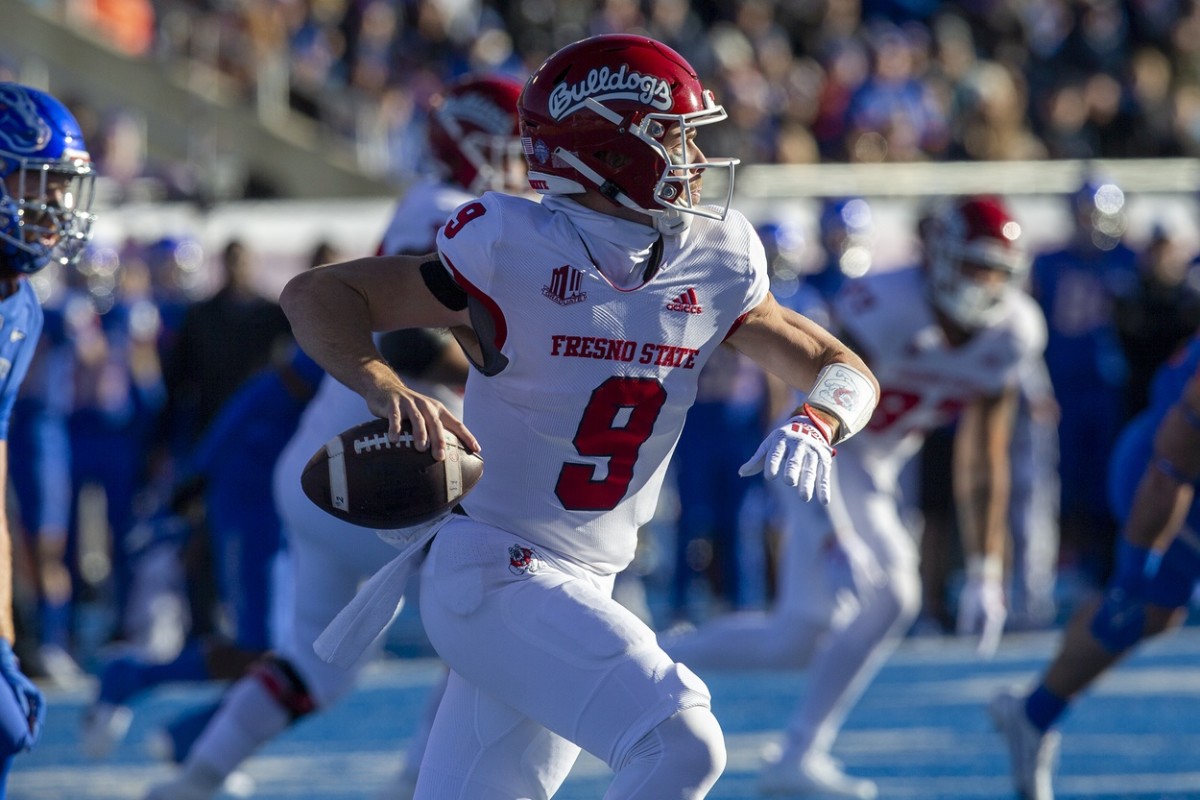 Fresno State Bulldogs quarterback Jake Haener (9) rolls out versus the Boise State Broncos. Mandatory Credit: Brian Losness-USA TODAY Sports