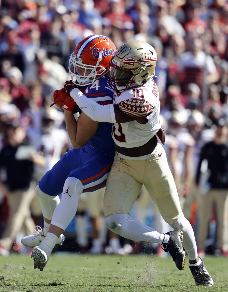 Florida State Seminoles defensive back Jammie Robinson (10) tackles Florida receiver Trent Whittemore (14). Mandatory Credit: Kim Klement-USA TODAY