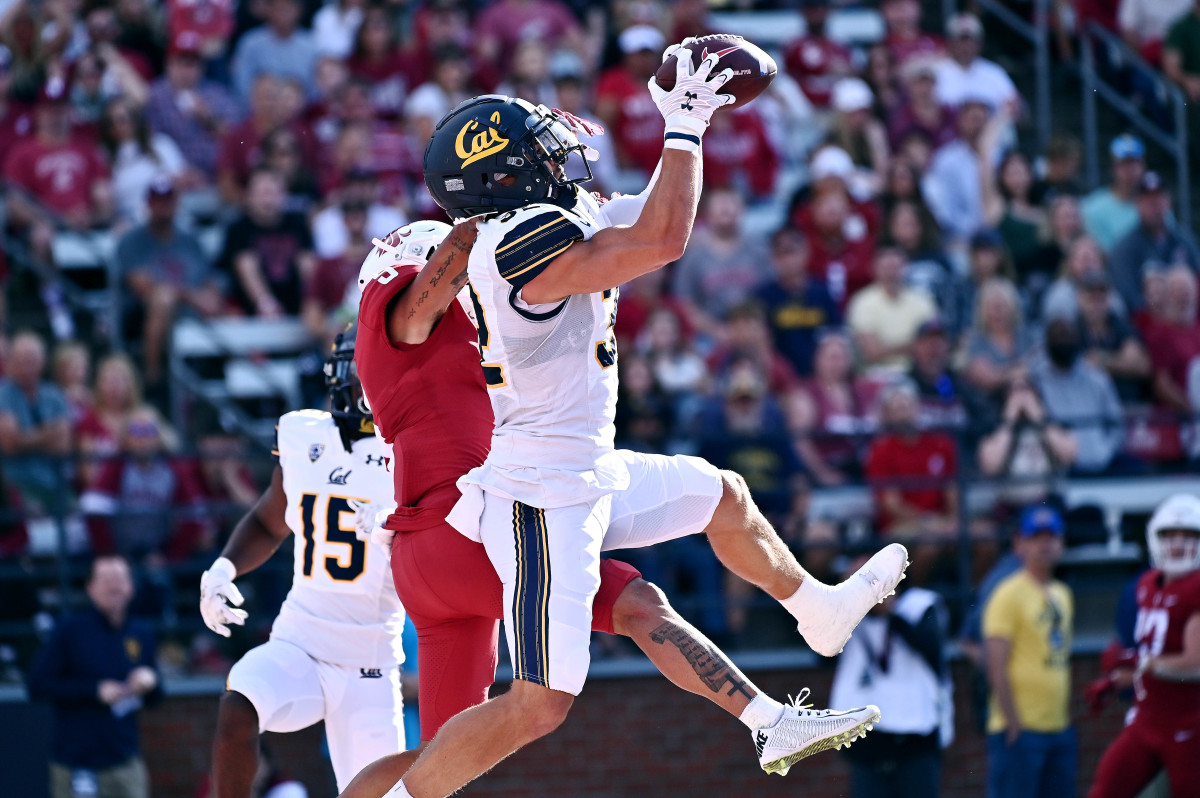Oct 1, 2022; Pullman, Washington, USA; California Golden Bears safety Daniel Scott (32) makes an interception in front of Washington State Cougars wide receiver Lincoln Victor (5) in the first half at Gesa Field at Martin Stadium. Mandatory Credit: James Snook-USA TODAY Sports