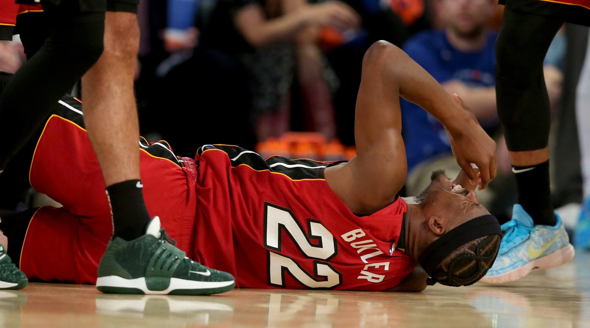 Jimmy Butler lays on the floor in pain after injuring his ankle against the Knicks in Game 1