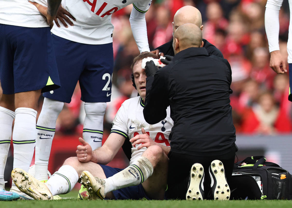 Tottenham midfielder Oliver Skipp pictured receiving medical treatment after being kicked in the head by Diogo Jota (not in shot) during a game at Anfield in April 2023
