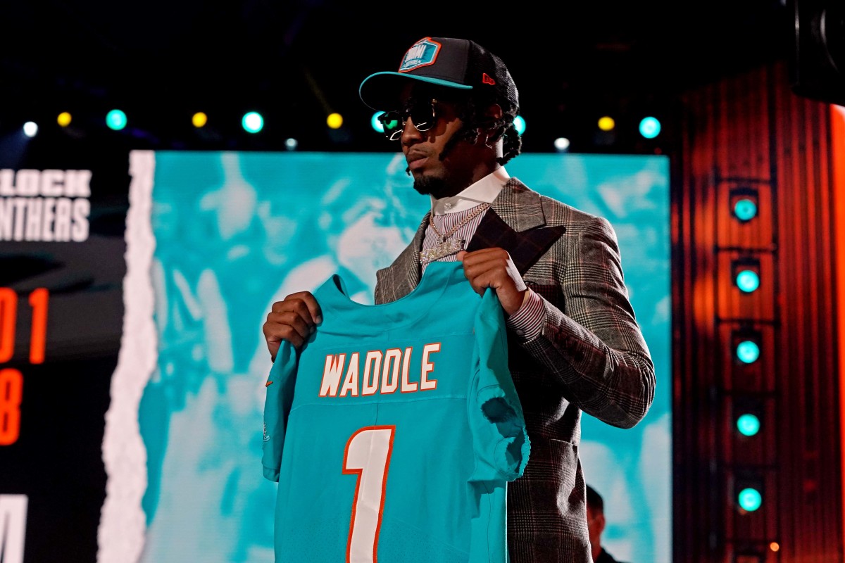 Jaylen Waddle (Alabama) poses with a jersey after being selected by Miami Dolphins as the number six overall pick in the first round of the 2021 NFL Draft at First Energy Stadium.