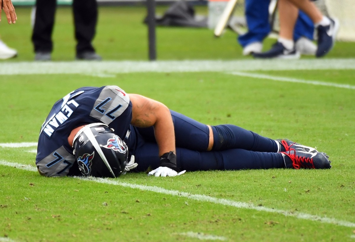 Taylor Lewan lays injured on the field in the Tennessee Titans 2020 game versus the Houston Texans. Lewan's recent legal action against the "doctor/entites" that repaired his torn ACL arose from this game.