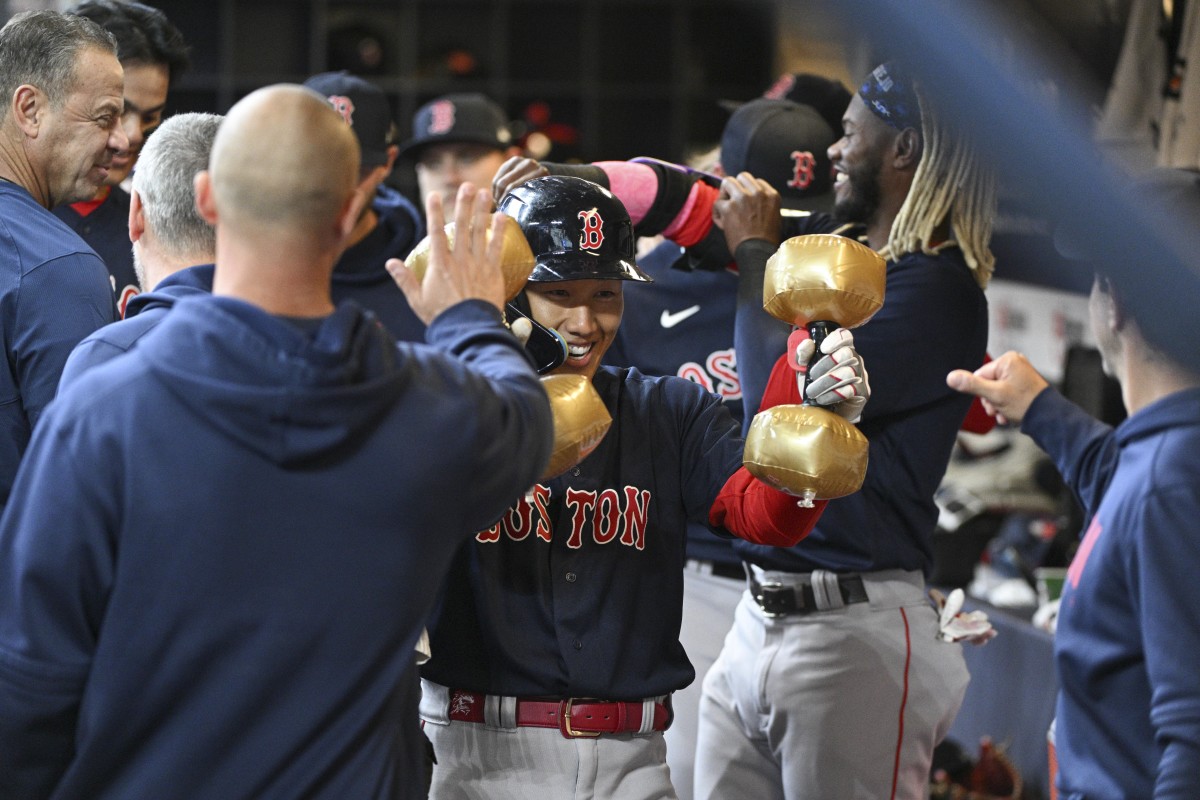 Red Sox players celebrate home runs with inflatable dumbbells.
