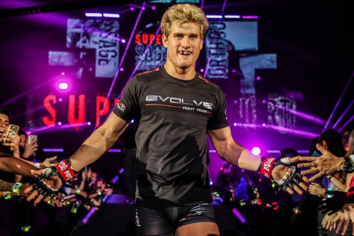 MMA fighter Sage Northcutt walks to the ring while high-fiving fans