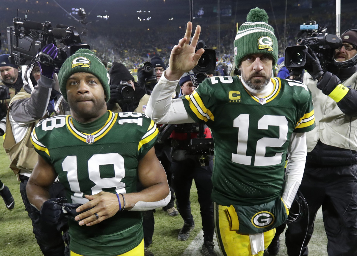 WR Randall Cobb (18) and QB Aaron Rodgers (12) leave Lambeau Field after the Packers' 2022 regular season finale