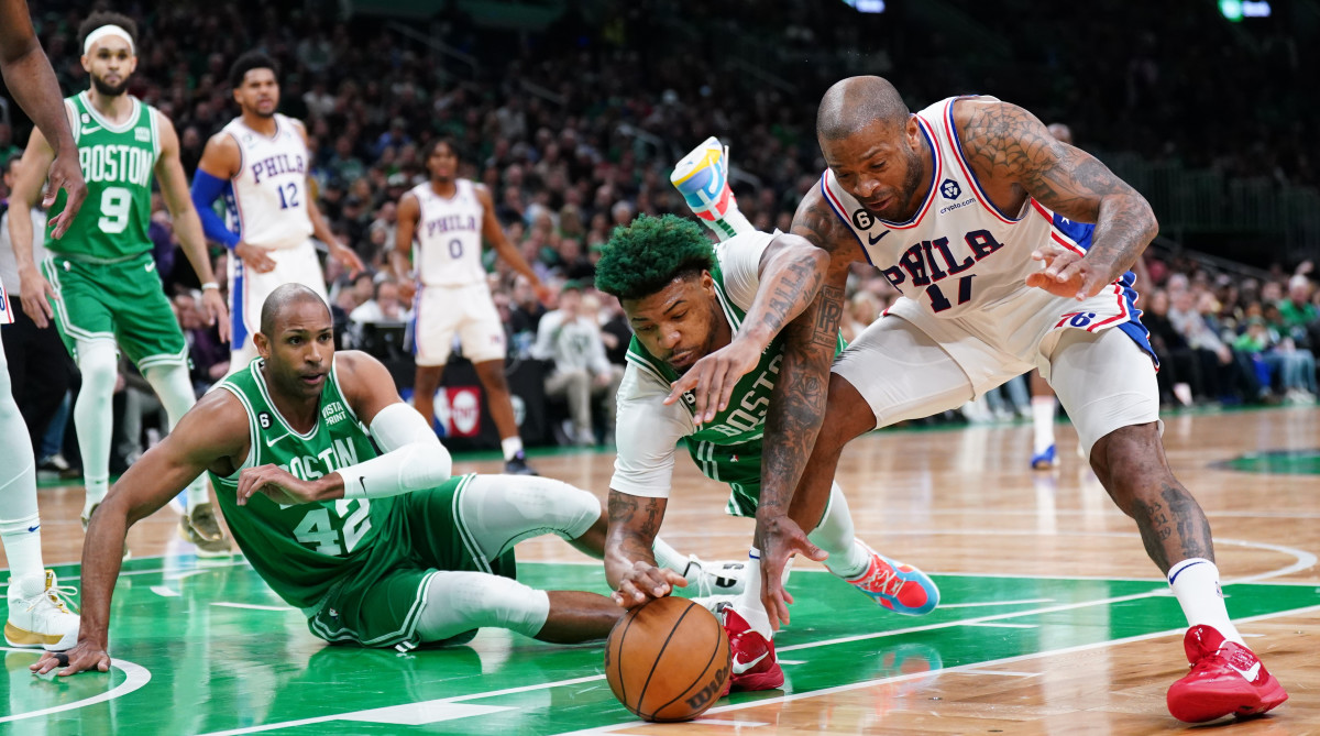 Celtics guard Marcus Smart works for the ball against Philadelphia 76ers forward P.J. Tucker.
