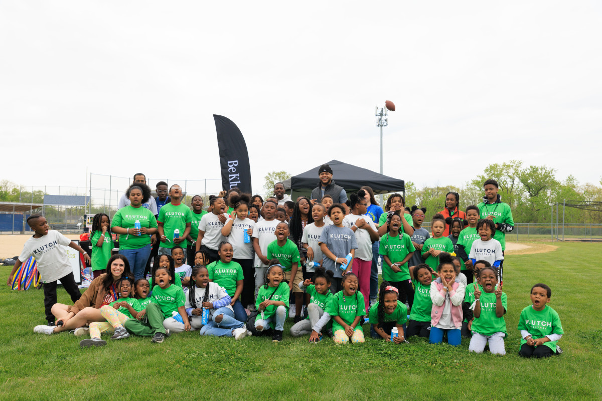 Washington Commanders DE Chase Young and Klutch Sports Group founder Rich Paul pictured with the kids of the Boys and Girls Club of Kansas City, Thornberry following the field day hosted by New Balance and Good Sports. (Photo provided by New Balance)
