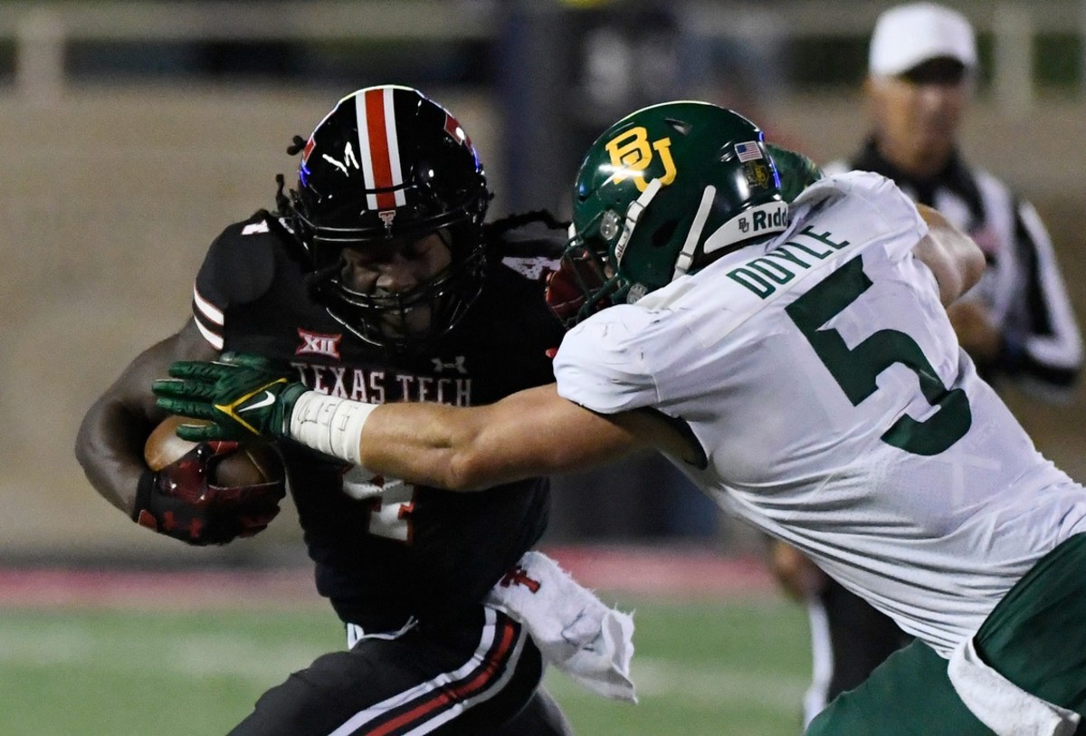 Texas Tech running back SaRodorick Thompson (4), left, runs with the ball against Baylor, Saturday, Oct. 29, 2022. Annie Rice/Avalanche-Journal / USA TODAY NETWORK