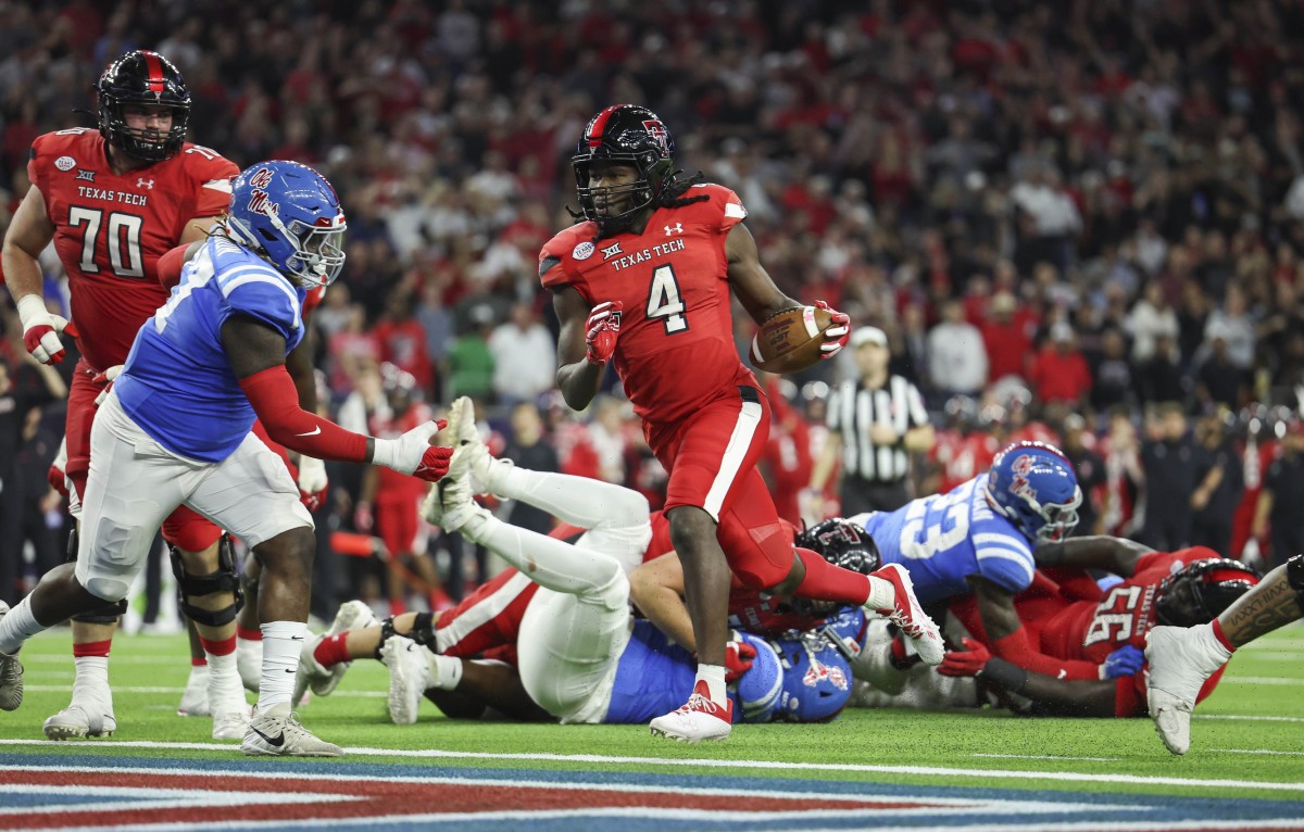 Texas Tech Red Raiders running back SaRodorick Thompson (4) runs for a touchdown against the Mississippi Rebels in the 2022 Texas Bowl. Mandatory Credit: Troy Taormina-USA TODAY Sports