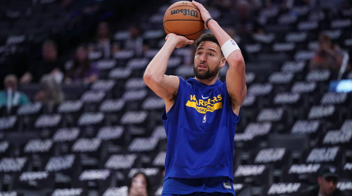Warriors guard Klay Thompson shoots a basketball during warmups before a game.