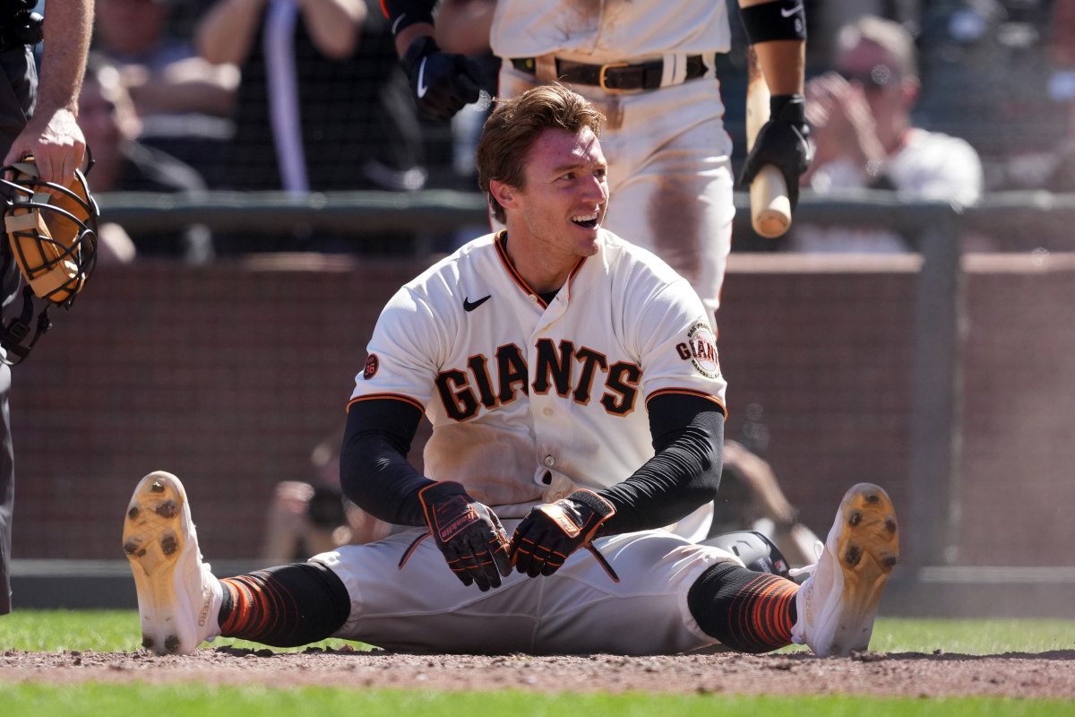 SF Giants center fielder Bryce Johnson sits on the ground after scoring a run against the Kansas City Royals. (2023)