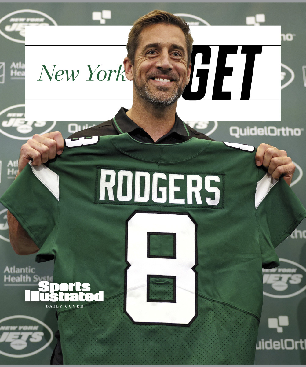 Aaron Rodgers holding up his new Jets jersey at a press conference, with text that says New York GET