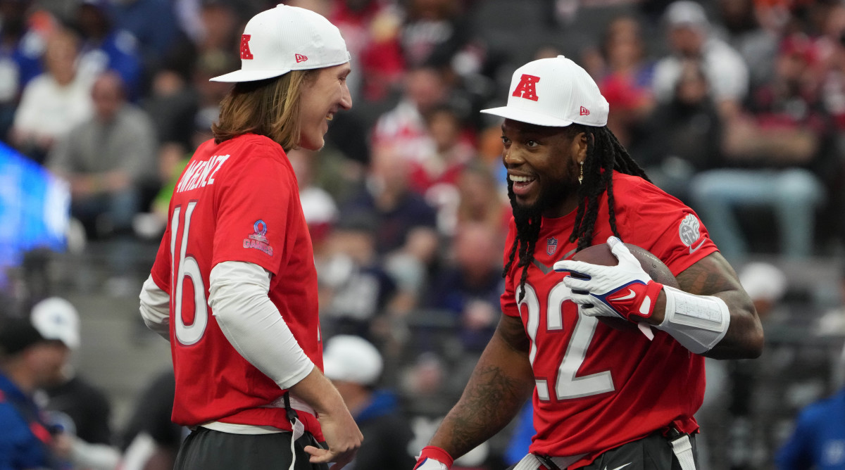 AFC quarterback Trevor Lawrence of the Jacksonville Jaguars and running back Derrick Henry of the Tennessee Titans smile at each other