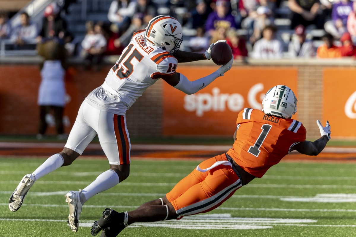 Feb 4, 2023; American defensive back Anthony Johnson Jr. of Virginia (41) intercepts a pass in front of National wide receiver Jayden Reed of Michigan State (1) during the Senior Bowl. Mandatory Credit: Vasha Hunt-USA TODAY Sports