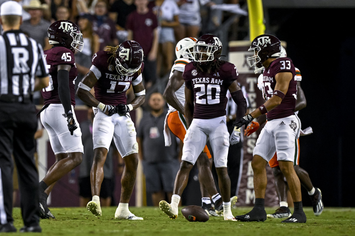 Sep 17, 2022; College Station, Texas, USA; Texas A&M Aggies linebacker Edgerrin Cooper (45) and defensive back Jaylon Jones (17) and defensive back Jardin Gilbert (20) and defensive back Jarred Kerr (33) celebrates a defensive top of the Miami Hurricanes during the second quarter at Kyle Field. Mandatory Credit: Jerome Miron-USA TODAY Sports
