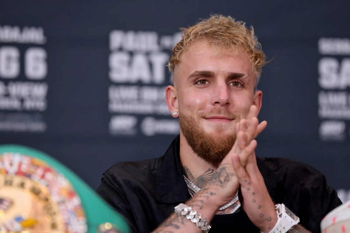 Jake Paul smiling during a press conference.