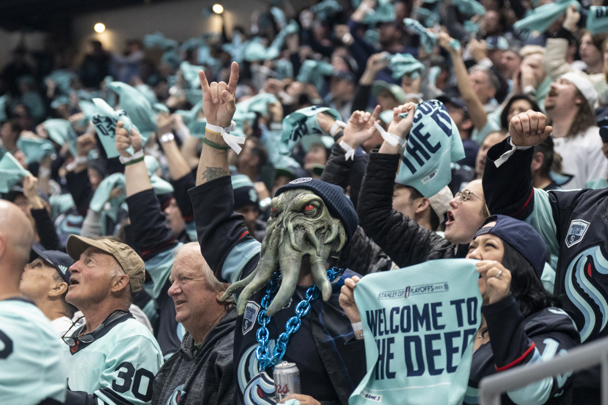 Seattle Kraken fans don sea monster headgear during a home game.