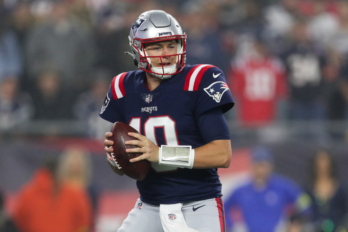 Patriots' QB Mac Jones drops back to pass in a 2022 game against Chicago