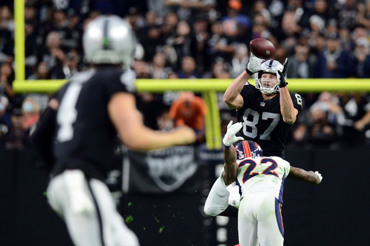 Las Vegas Raiders tight end Foster Moreau (87) catches a pass against Denver Broncos safety Kareem Jackson (22) from Las Vegas Raiders quarterback Derek Carr (4)