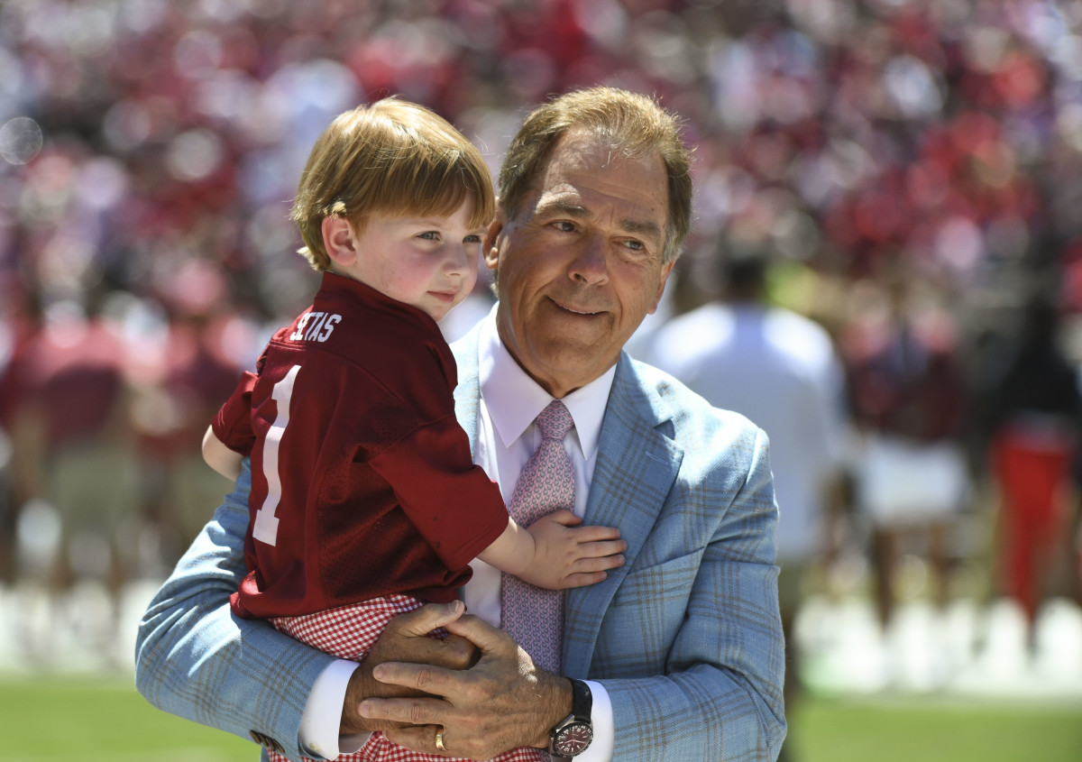Alabama head coach Nick Saban holds his grandson before the A-Day game at Bryant-Denny Stadium.
