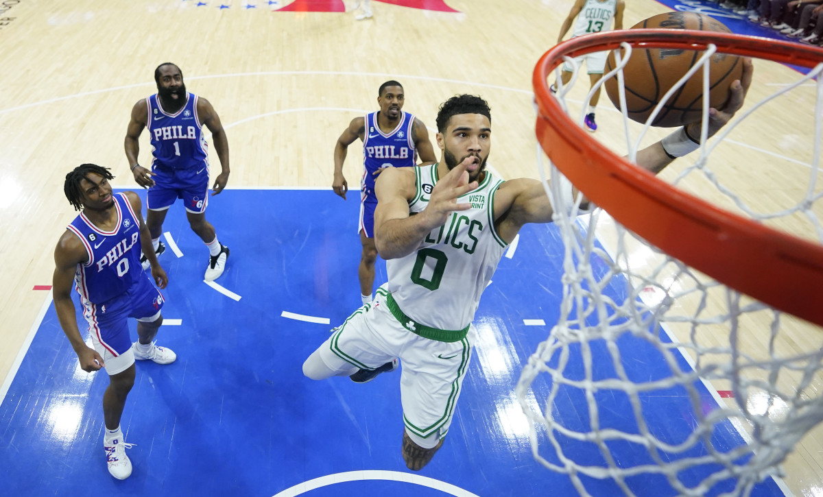 Celtics' Jayson Tatum, right, shoots against Philadelphia 76ers' Tyrese Maxey, left, James Harden and De'Anthony Melton during the Eastern Conference semifinals.