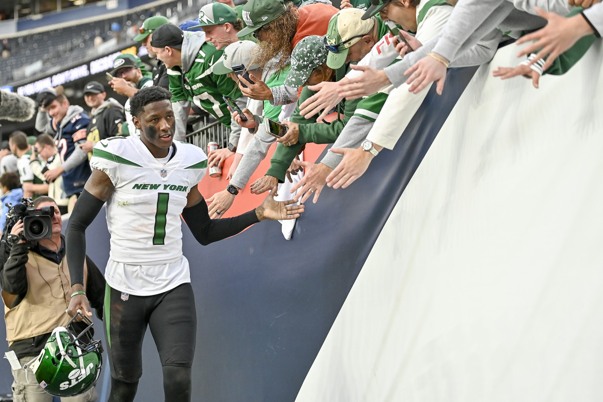 Sauce Gardner high-fives fans after a game with the Jets.