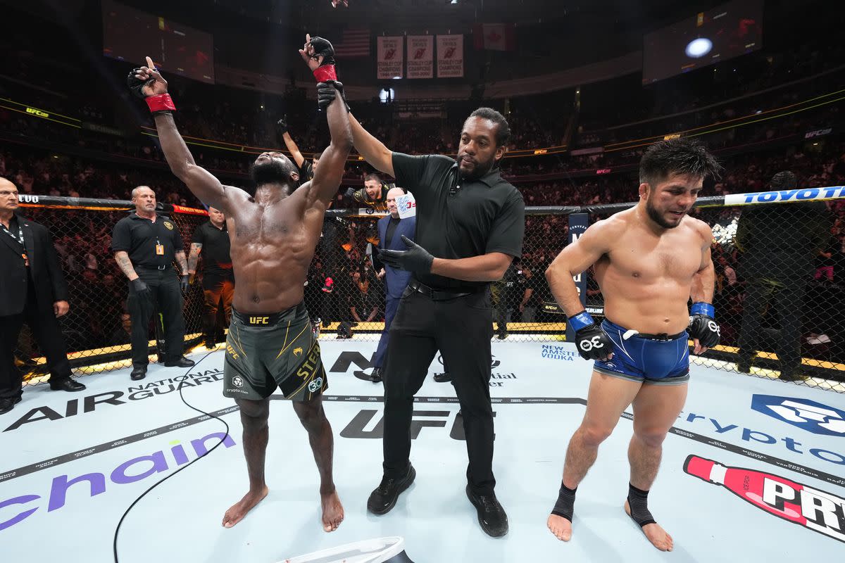 Aljamain Sterling has his hand raised after his bantamweight title fight against Henry Cejudo at UFC 288.