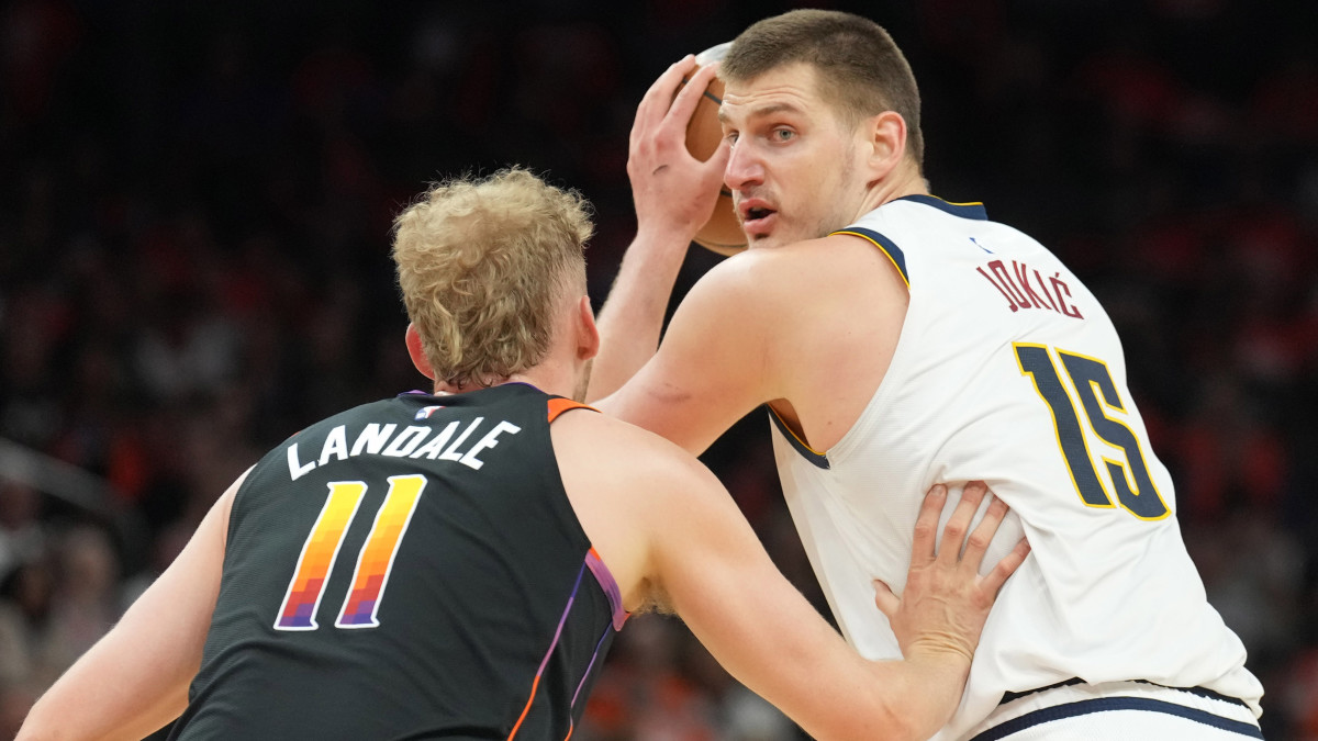 Phoenix Suns center Jock Landale guards Denver Nuggets center Nikola Jokic.