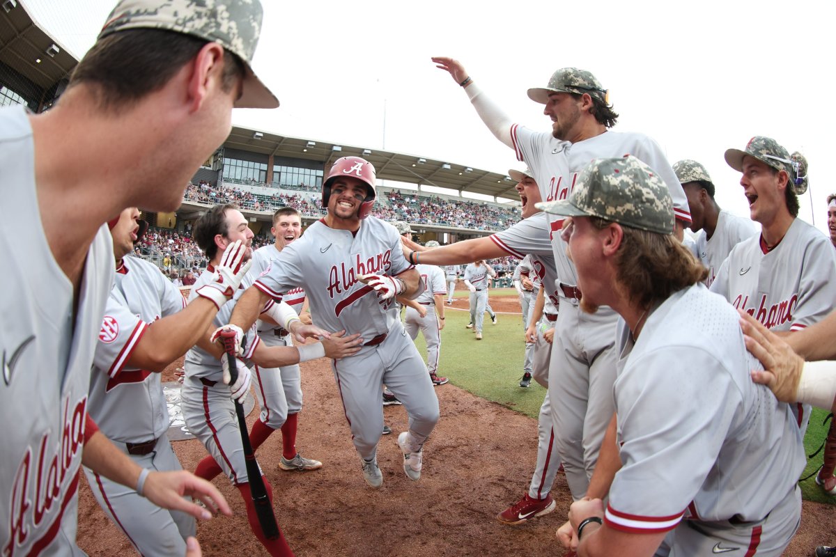 Alabama Baseball's Tommy Seidl (20) celebrates with teammates after hitting a home run in the Crimson Tide's 11-0 win over the Texas A&M Aggies at Olsen Field at Blue Bell Park in College Station, Texas.