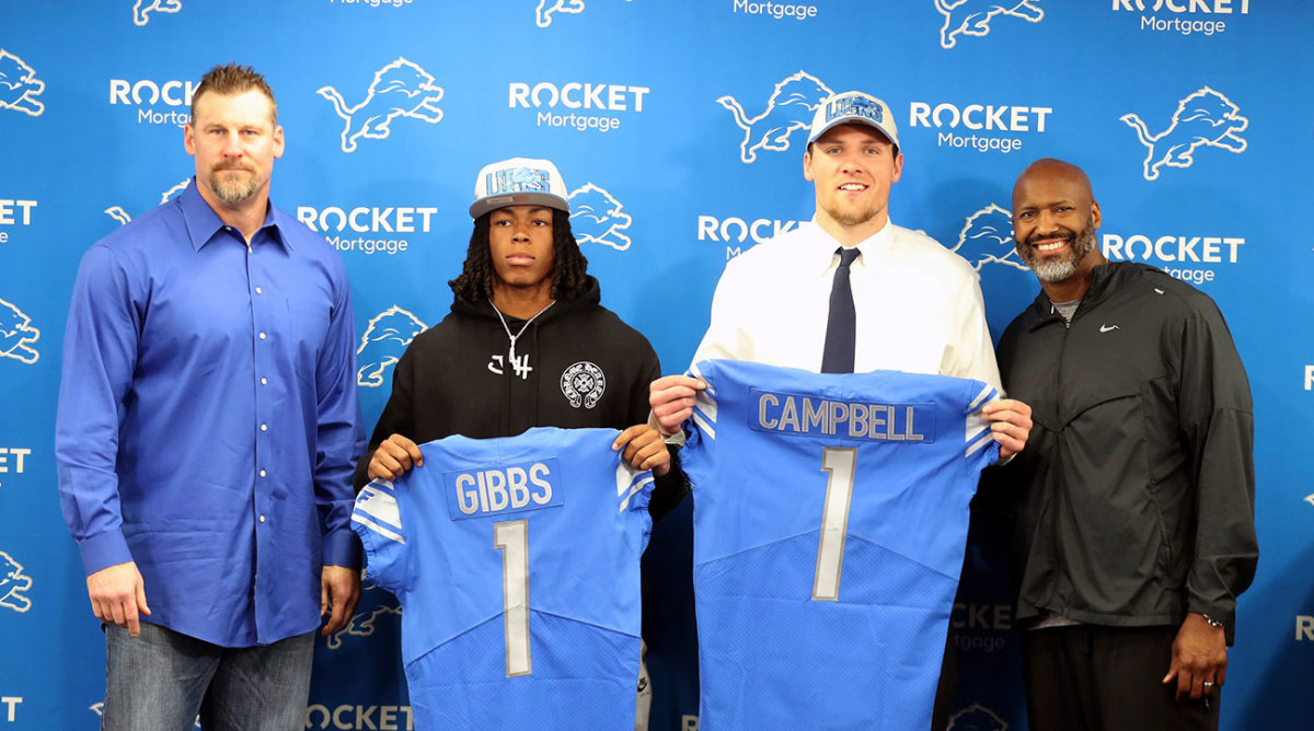 Jahmyr Gibbs and Jack Campbell hold up Lions jerseys after being drafted