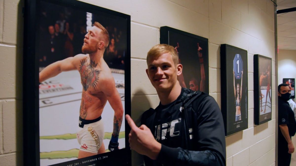 UFC welterweight Ian Garry points at a portrait of Conor McGregor doing his signature power walk inside the Octagon.