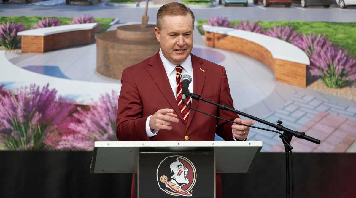 Florida State athletic director Michael Alford speaks at a podium