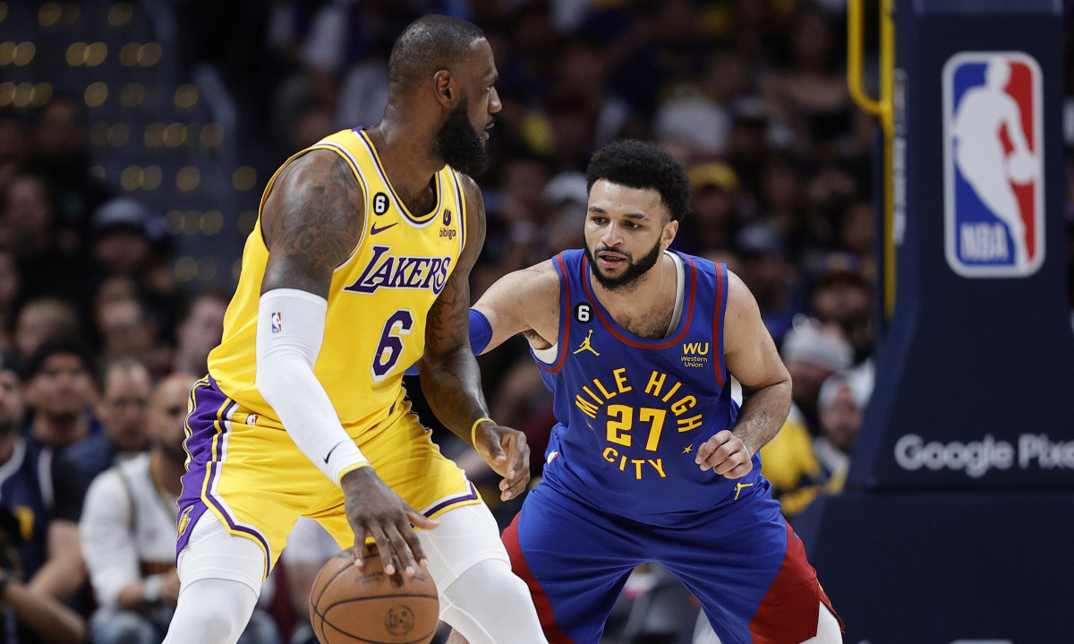 Lakers forward LeBron James controls the ball against Nuggets guard Jamal Murray in Game 1