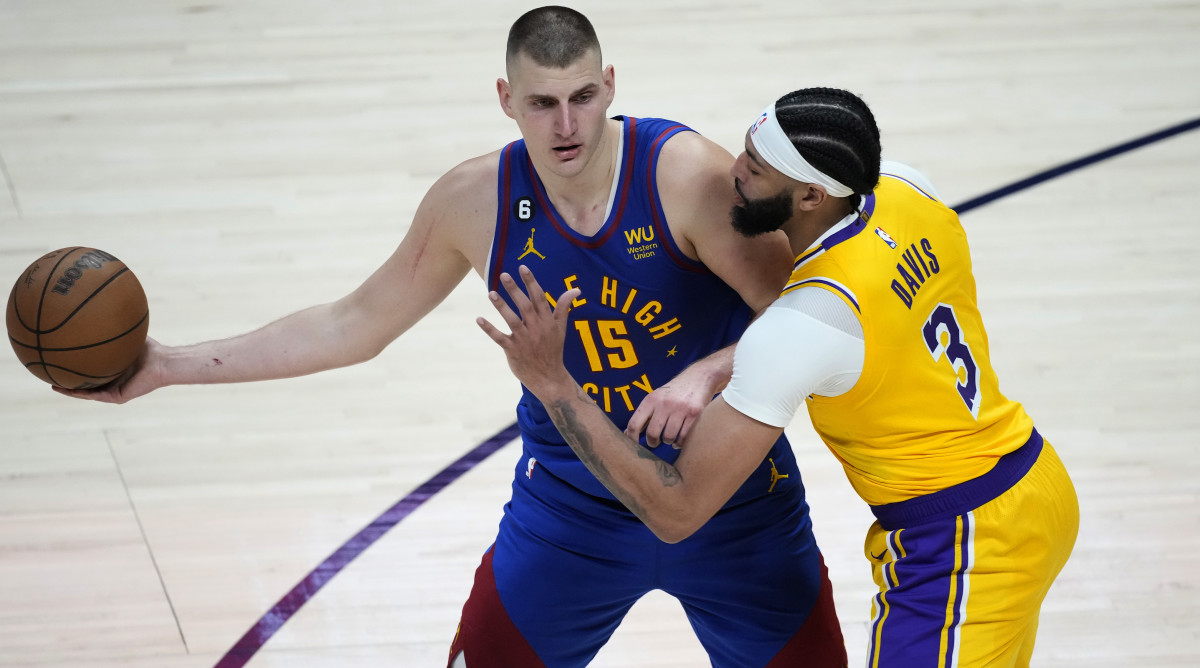 Nuggets center Nikola Jokić looks to pass as Lakers forward Anthony Davis defends during Game 1