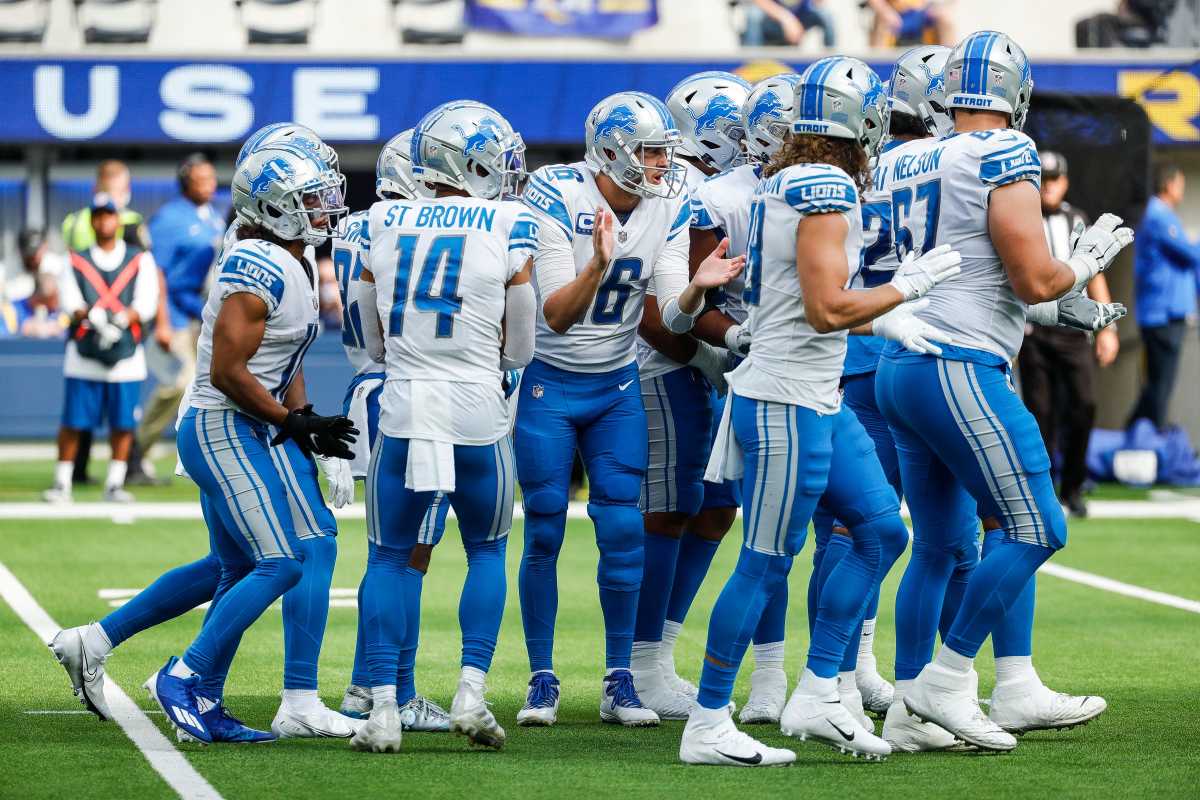 Detroit Lions quarterback Jared Goff claps his hands together as he huddles with teammates before a first down